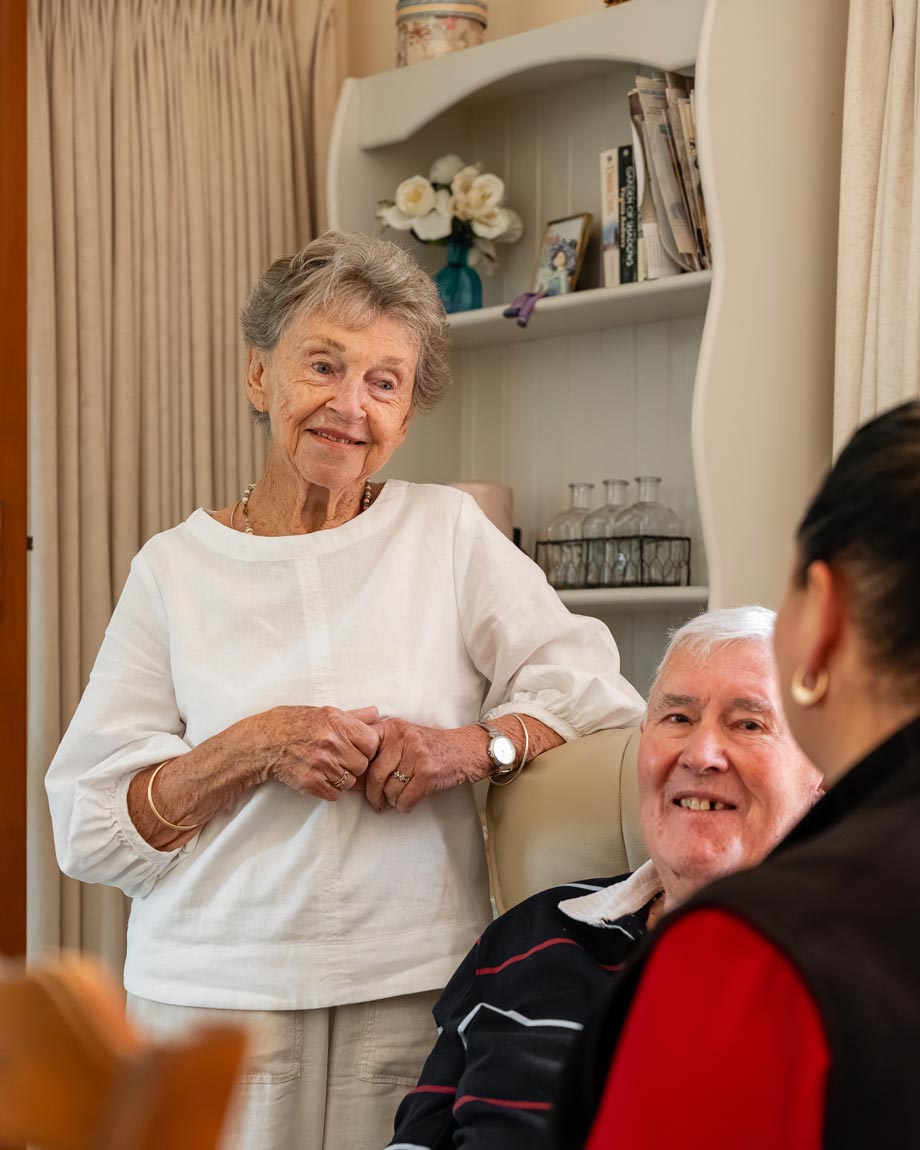 Elderly couple having a conversation with with one of MHA Care supportive employees