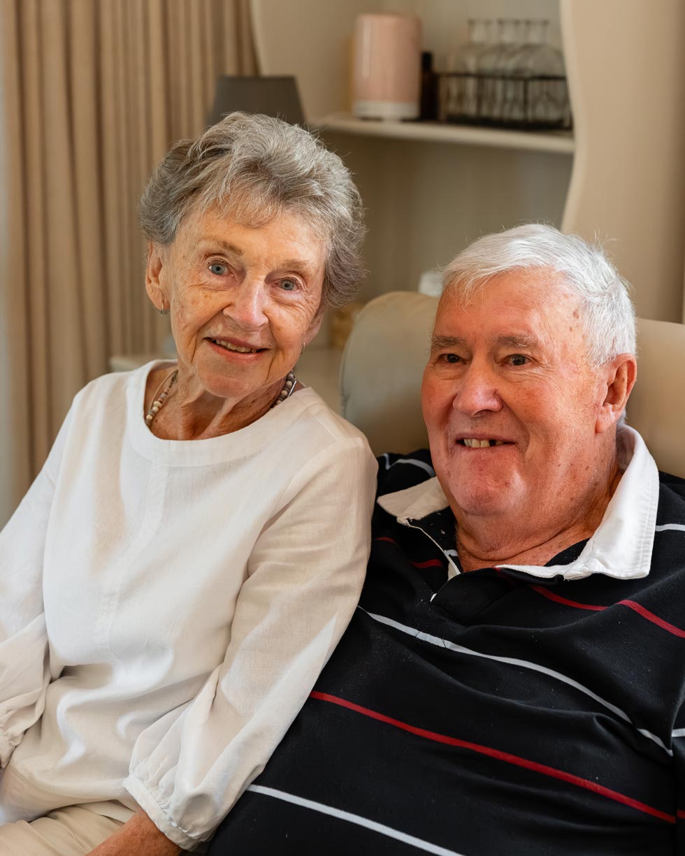 Elderly couple smiling at the camera